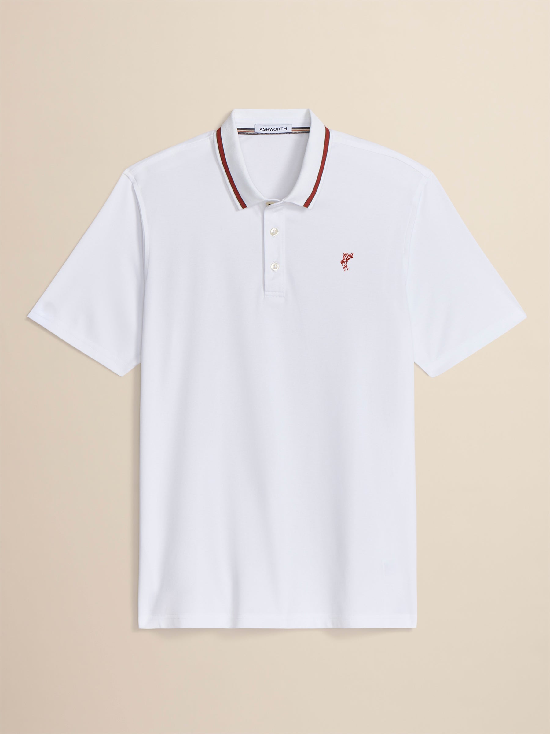 White polo shirt with red accents on a beige background