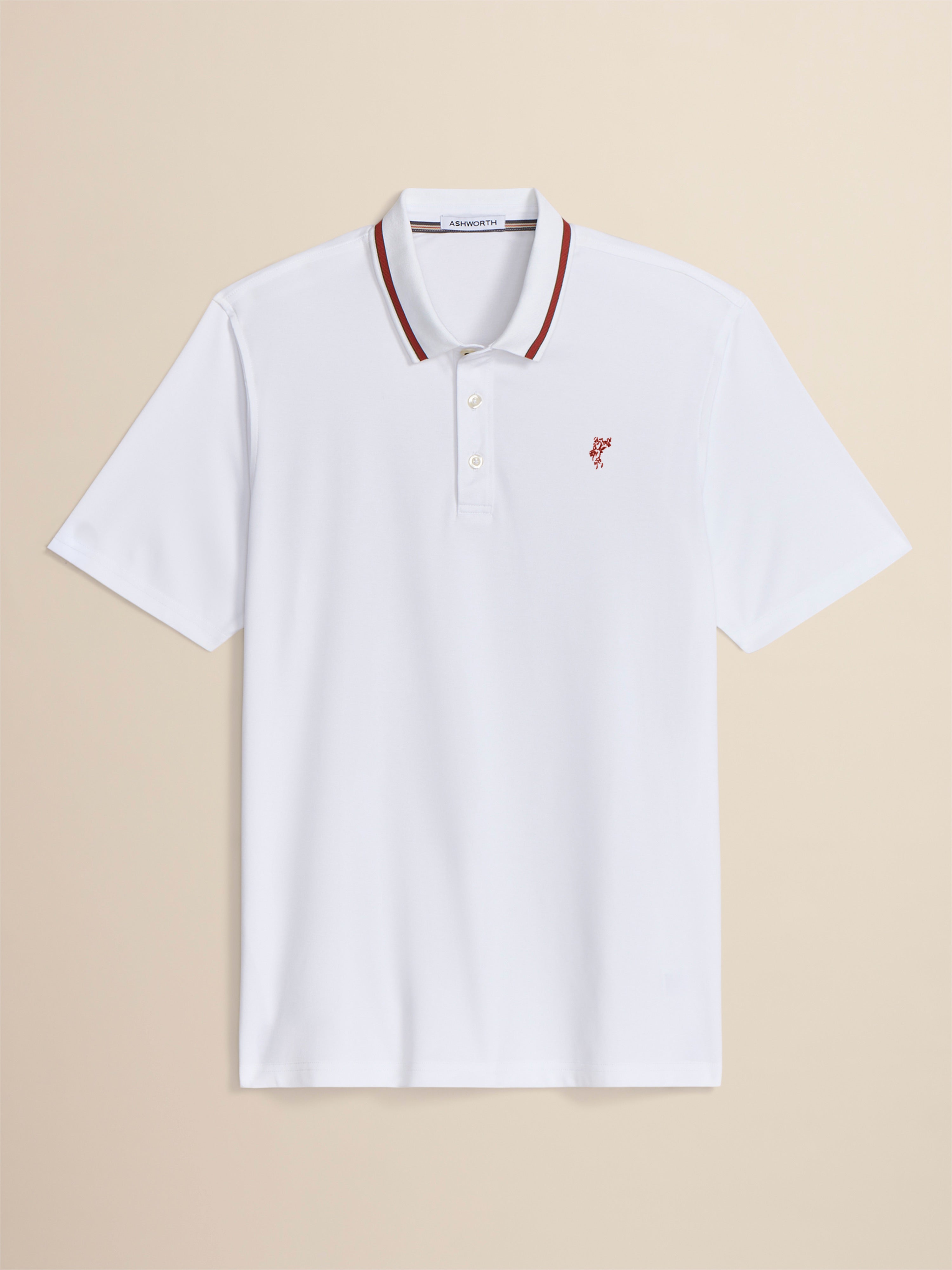White polo shirt with red accents on a beige background