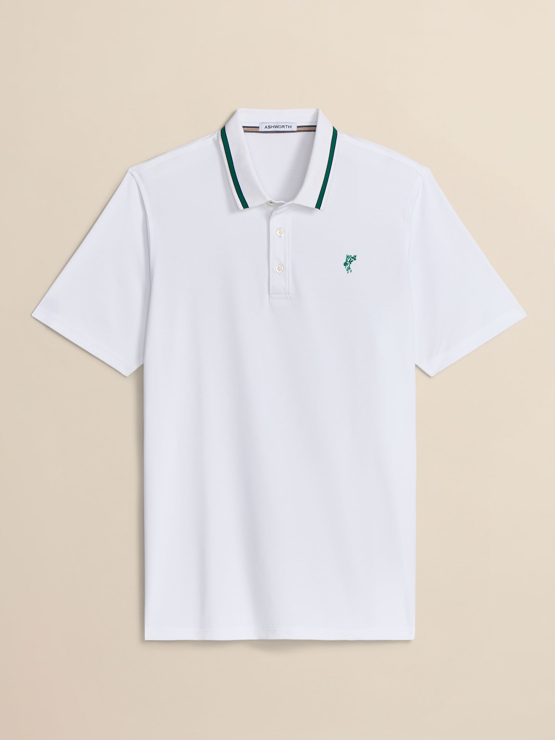 White polo shirt with green accents on a beige background